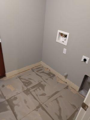 Prepping the tile with a skim coat prior to putting down laminate.