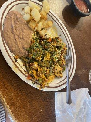 Cactus with chorizo, eggs, onion and tomatoes. I added cilantro. It was served with beans potatoes and flour tortillas.