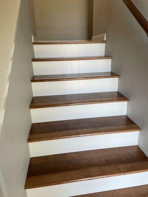 Removed carpet and placed hardwood treads with white risers.