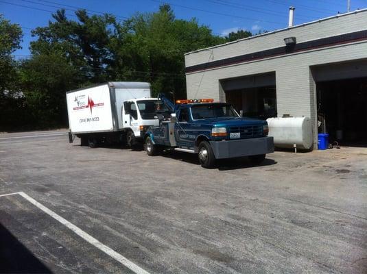 Medium duty box truck being towed to repair shop