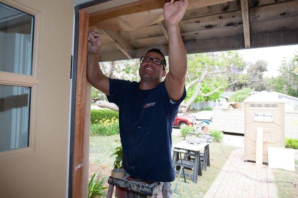 Installing the front door of a job.