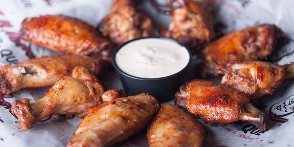 Smoked wings served with Alabama white sauce.