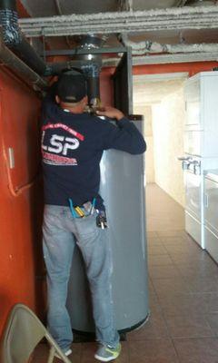 Local Service Pro Plumbing tech Rafael working on installing a new water heater.