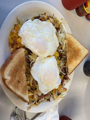 Corned beef skillet with eggs over easy and buttered toast