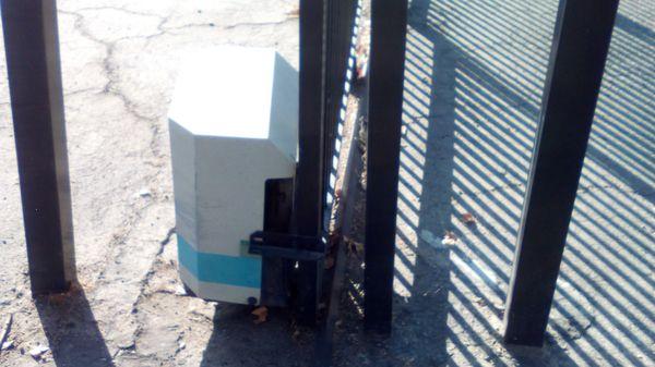 Missing motor on non-working security gate on the parking lot. Both gates are non-functional.