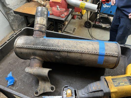 A customer with a backhoe wanted us to fabricate a replacement for this odd muffler.