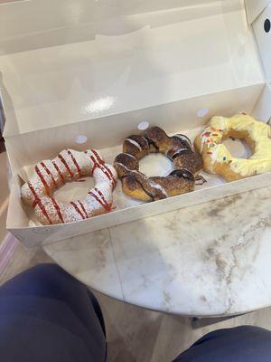 Strawberry funnel, Hershey, and mango cheesecake dough nuts.