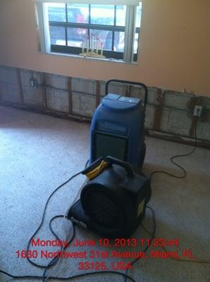 Dehumidifiers and fans being used to dry out a water damaged unit to prevent mold growth