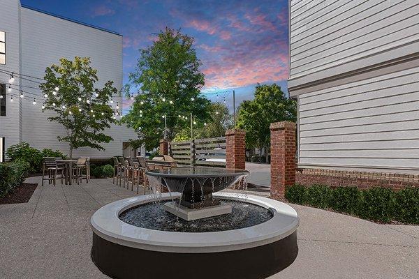 Spacious courtyard with fire pits, grilling station and dining area