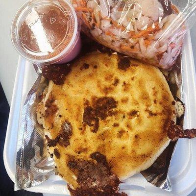 Salvadoran pupusa with chicharrón con queso filling, traditional curtido (slaw), and house-made salsa.