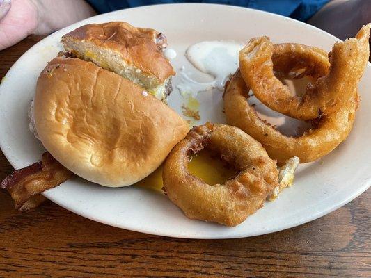 Bacon egg and cheese burger with onion rings on the side. Amazing food and taste 10/10 rating on food.