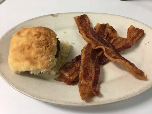 Salmon on biscuit with bacon on the side