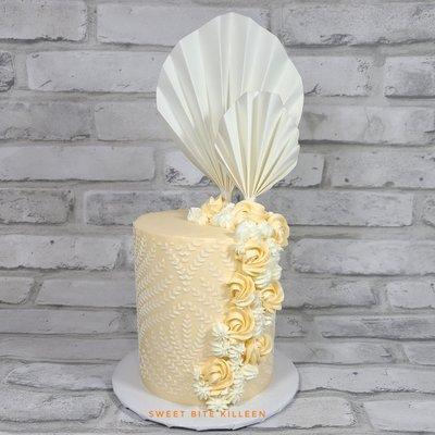 Red velvet cake with vanilla buttercream and edible fan decorations