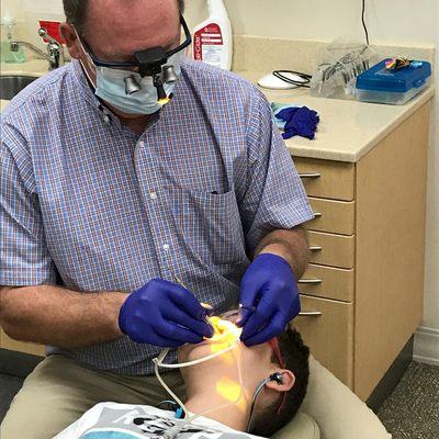 Dr.Ogden hard at work fixing braces on a patient.