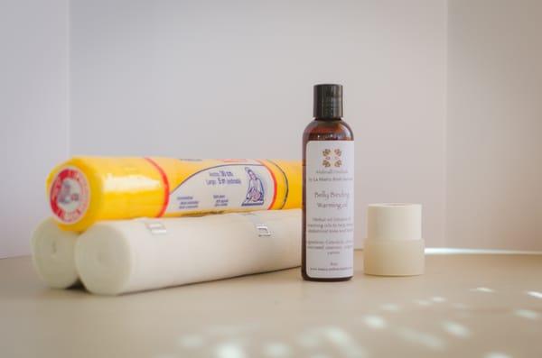 Gentle bandage binding for the immediate postpartum hours with warming bellying binding oil.