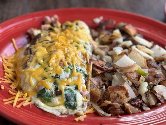 Build your own omelette. This one had mushroom, cheddar cheese, ham, spinach. Served with Potatoes.