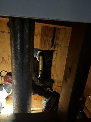 Pipes underneath upstairs shower where leak was coming from.