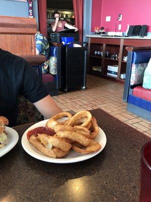 A waitress pulling up her mask, above her mouth, NOT HER NOSE.