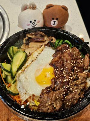 Beef bugogi (in a stone pot) on a bed of rice