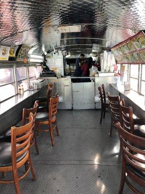 The bus with bar seating inside.. and great cooking going on in the back.