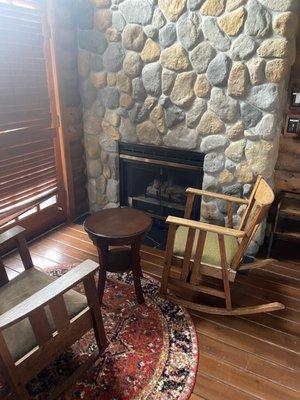 Cute fireplace. The blinds are covering the pretty doors leading out to the balcony