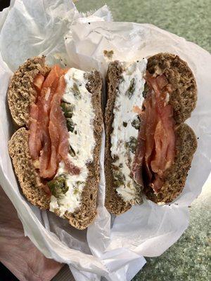 Toasted whole wheat everything bagel with lox, cream cheese, tomato, onions and capers