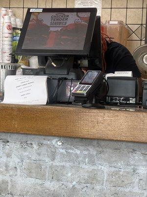 Rude lady hiding behind the register eating chicken wings while I wait