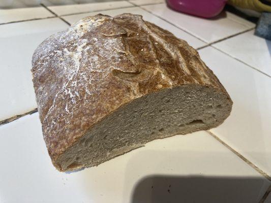 A loaf of spelt bread that is mid.