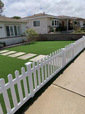 Artificial grass with concrete stepping stones