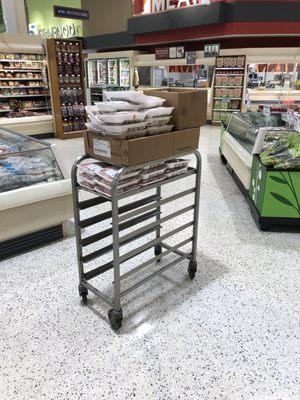 A cart full of chicken left to rot in the middle of the floor after hours.