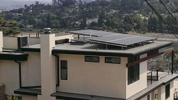 One of my installs. This was for an engineer who designed his beautiful home. Because it has a flat roof we had to tilt the solar array