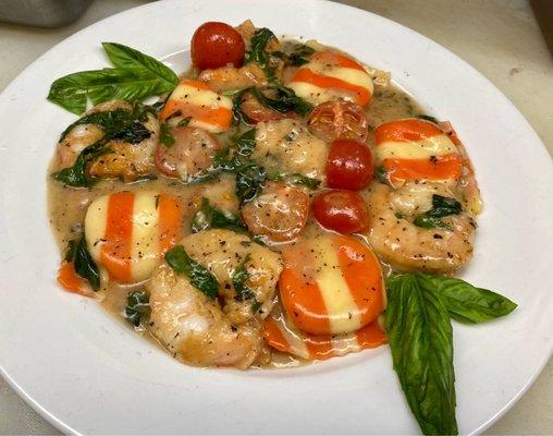 Lobster raviolis with jumbo shrimp roasted tomatoes and lemon basil sauce