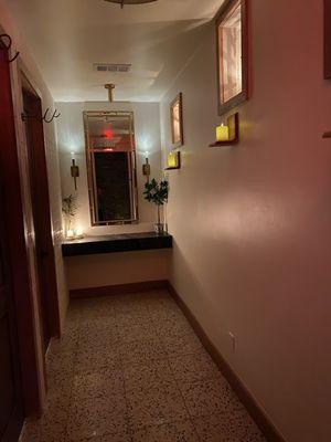 A hallway leading to the restrooms