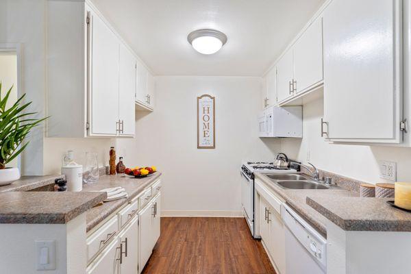 Spacious kitchen with a stove, dishwasher, and microwave at the Parkview in Lake Balboa