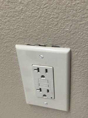 Electrical plug holder pulling out from the wall