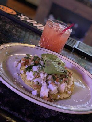 Shrimp tostada and drink at the bar