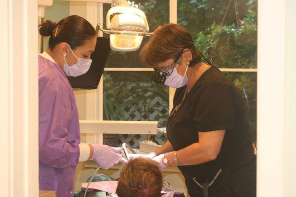 Dr. Gonzalez and assistant Zio working on a patient