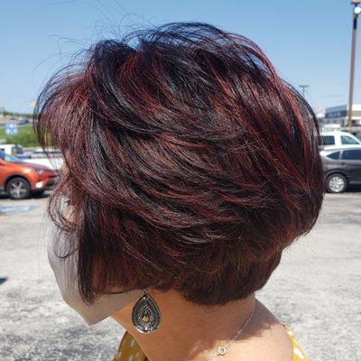 Red violet high lights on dark brown hair.