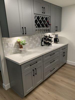 Designed a bar area for the client with storage. Under cabinet lighting with black cabinet hardware.