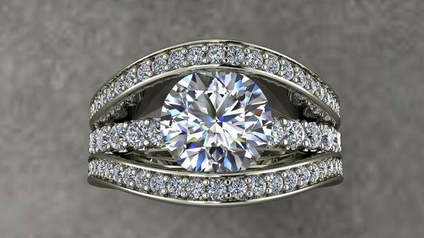 Custom designed in 14kw gold with 2 ct. center, 1.5 ct. side diamonds.