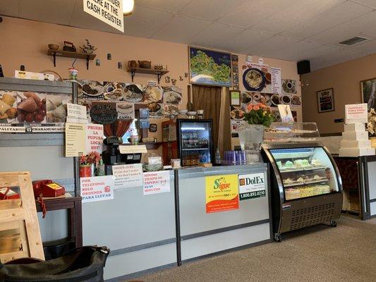 Front of the store. There are lots of pictures of the food to help you choose what you might want.  The glass case has all kinds of cakes.