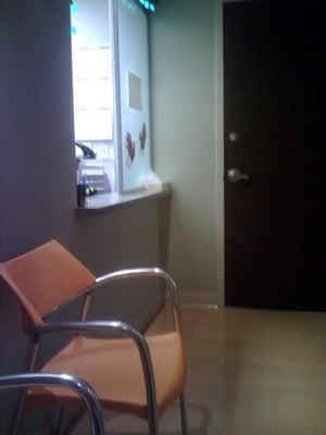 Inside waiting room.  Simple with plastic chairs.