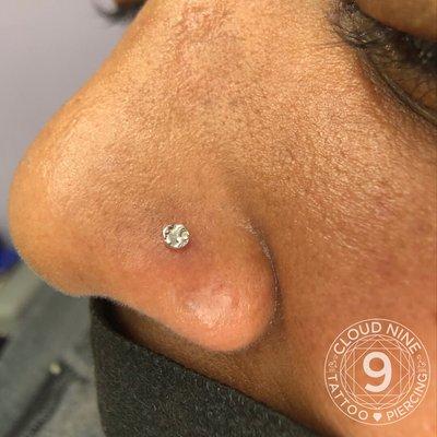 Fresh nostril piercing with 14kt white gold hammered disc by Karri, Cloud 9.