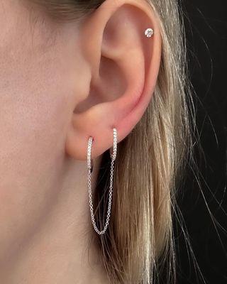 Double trouble! Handcuff diamond earrings are a must, on trend double hoops with connecting chain 14k gold