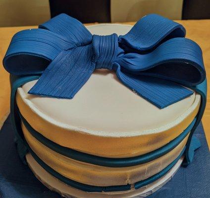 Custom cake by request, rolled fondant all around and the bow on top.