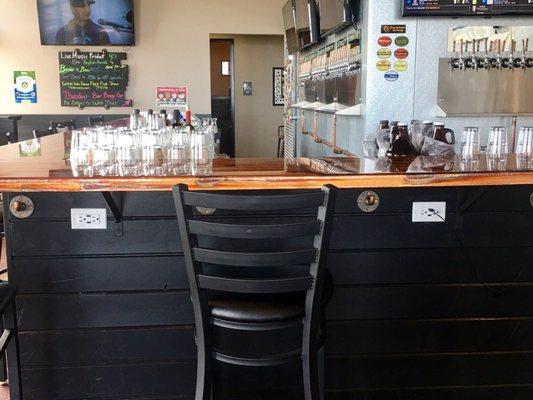 Charging stations underneath bar with USB ports.