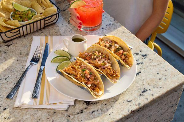 Sit down & enjoy our street tacos with a side of guac!