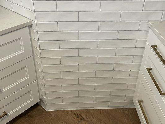 After picture, Backsplash was able to be extended down to floor with no baseboards in kitchen