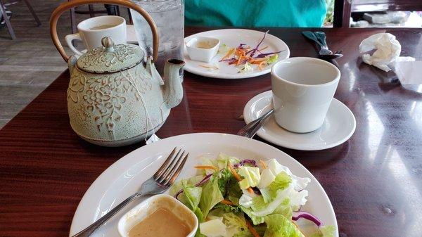 Hot tea and peanut dressing salad that comes with your meal