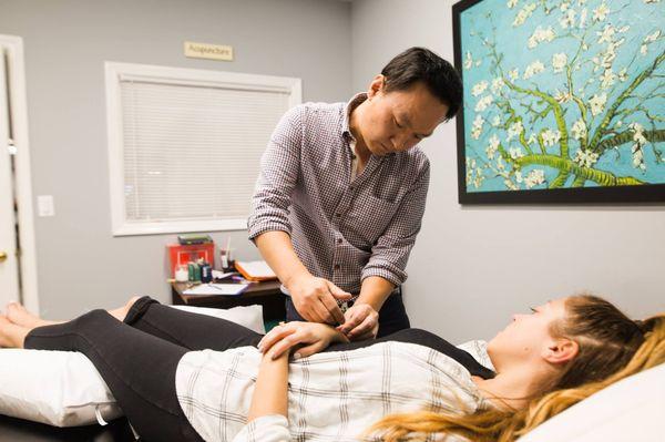 Hugh Kim performing acupuncture at our Shrewsbury Treatment Center